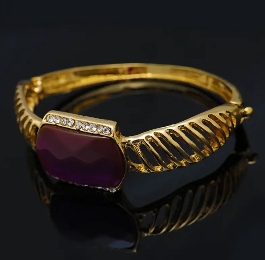 Amazing five piece gold,rhinestone set with purple emblems.