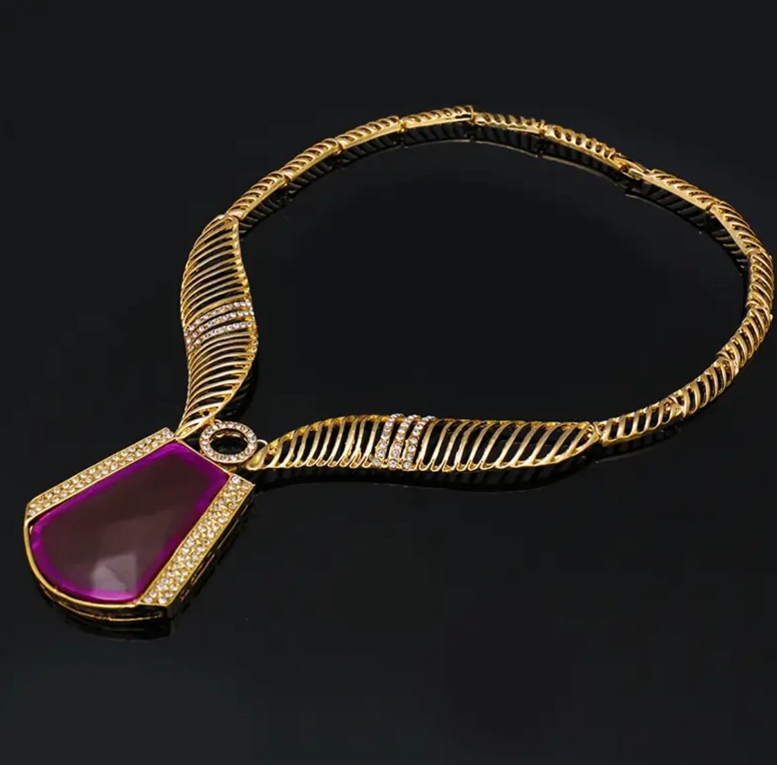 Amazing five piece gold,rhinestone set with purple emblems.
