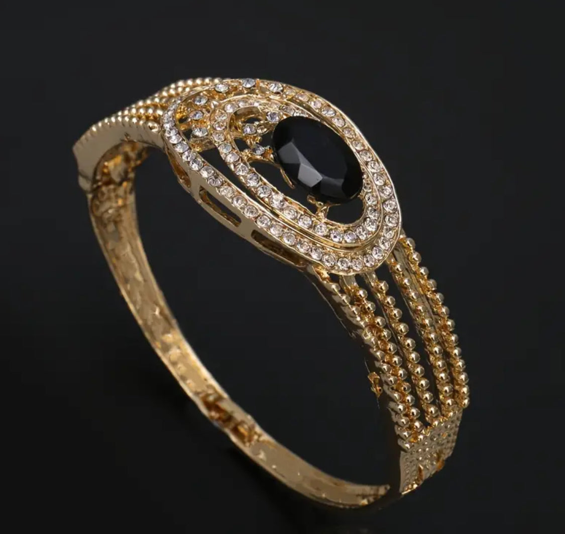 Gorgeous five piece gold, rhinestone set embellished in black stones.